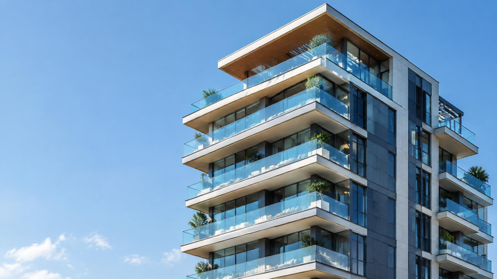 Luxury residential building with glass balconies against the sky