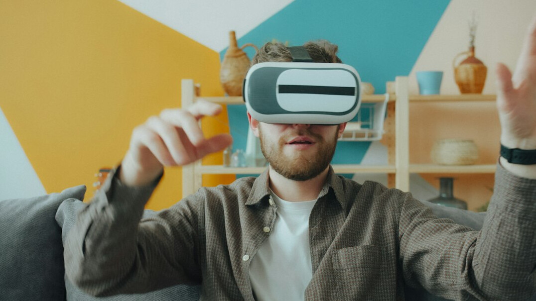 person wearing vr glasses at home