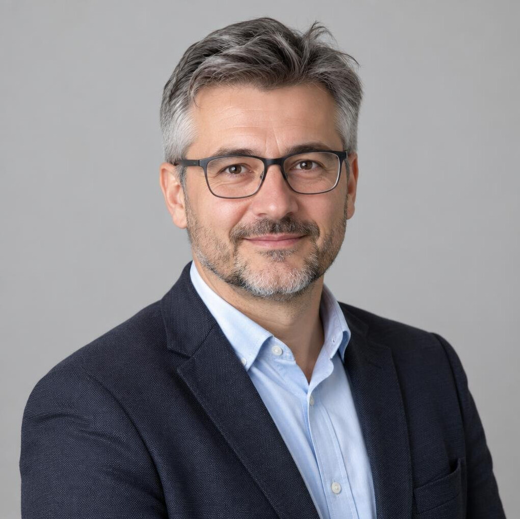 Studio portrait of a Croatian man editorial team member with glasses